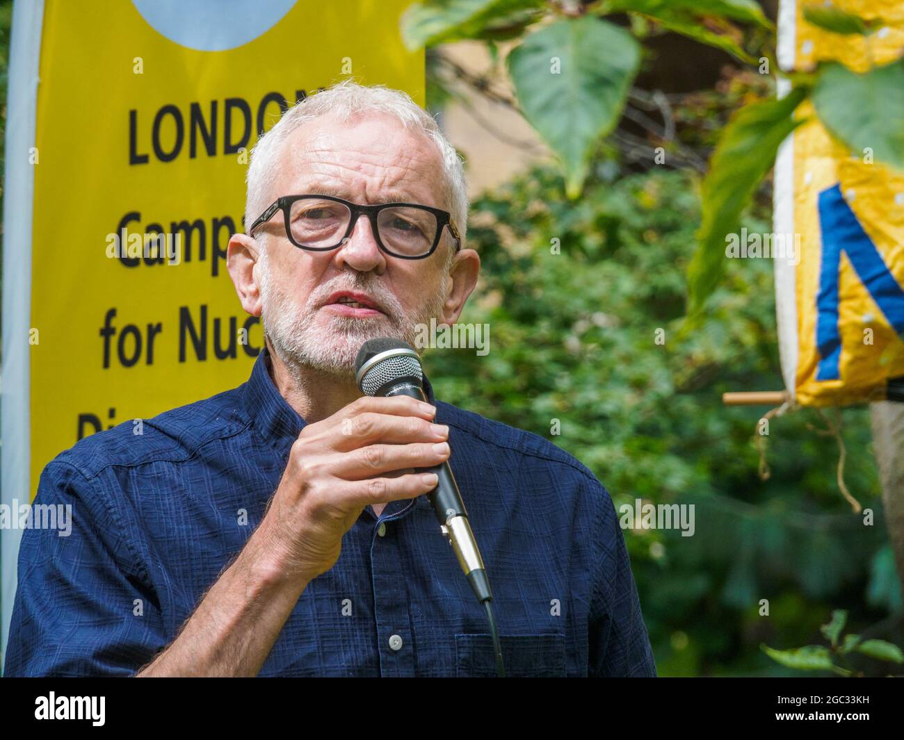 London, UK. 6th August 2021. Islington MP Jeremy Corbyn speaks. 76 years after atomic bombs were dropped on Hiroshima and Nagaski, London CND met at the Hiroshima Cherry tree in Tavistock Square to remember the many killed and survivors who are still suffering the event, and to celebrate the UN treaty prohibiting nuclear weapons which came into force this January. They called on the government to end the UK's nuclear weapon programme. Peter Marshall/Alamy Live News Stock Photo
