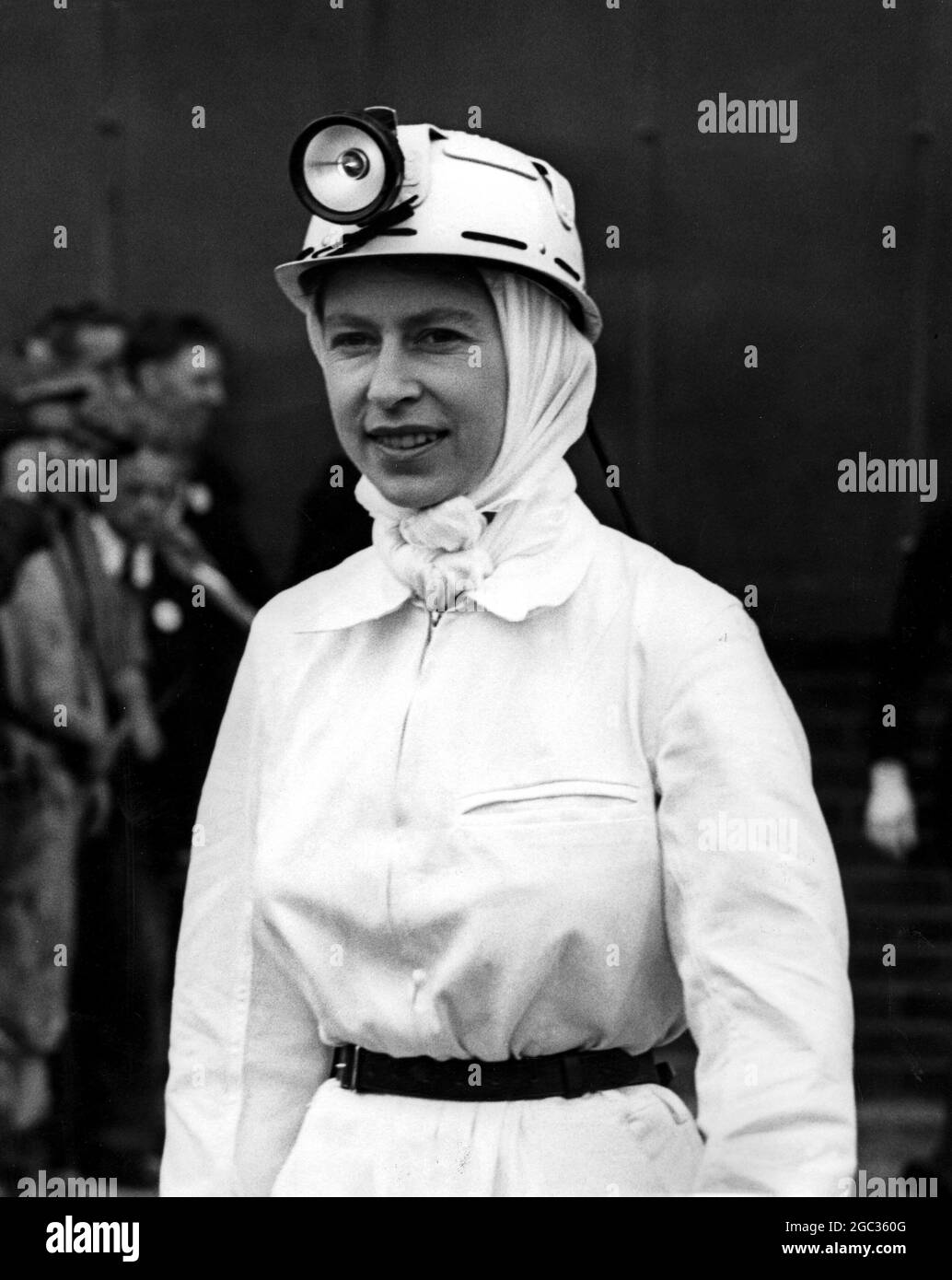The Queen, wearing a full miner's uniform, pictured before she went a third of a mile down the Rothes Colliery, Scotland, yesterday. This was a new experience for Her Majesty, and she took full advantage of it, wearing a pit helmet, overalls and boots and carrying a miner's lamp. The mine is in Kirkcaldy, Scotland. Prince Philip also went down. 1st July 1958 Stock Photo