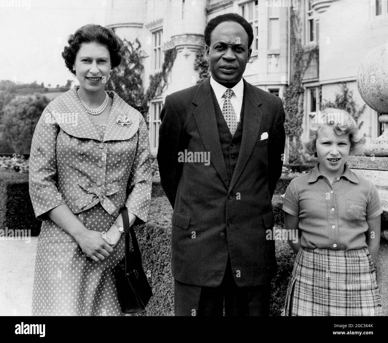 The Prime Minister of Ghana, Dr Nkrumah, yesterday visited Her Majesty the Queen and the Duke of Edinburgh who are now on holiday with their children, at Balmoral Castle. He had gone to discuss possible future arrangements for a royal tour of his country - the visit arranged for this autumn having been cancelled because of the impending birth of a baby to Her Majesty. On the occasion of his visit he was made a privy councillor by the Queen. This picture shows Dr Nkrumah with her majesty the Queen and Princess Anne. August 1959 Stock Photo