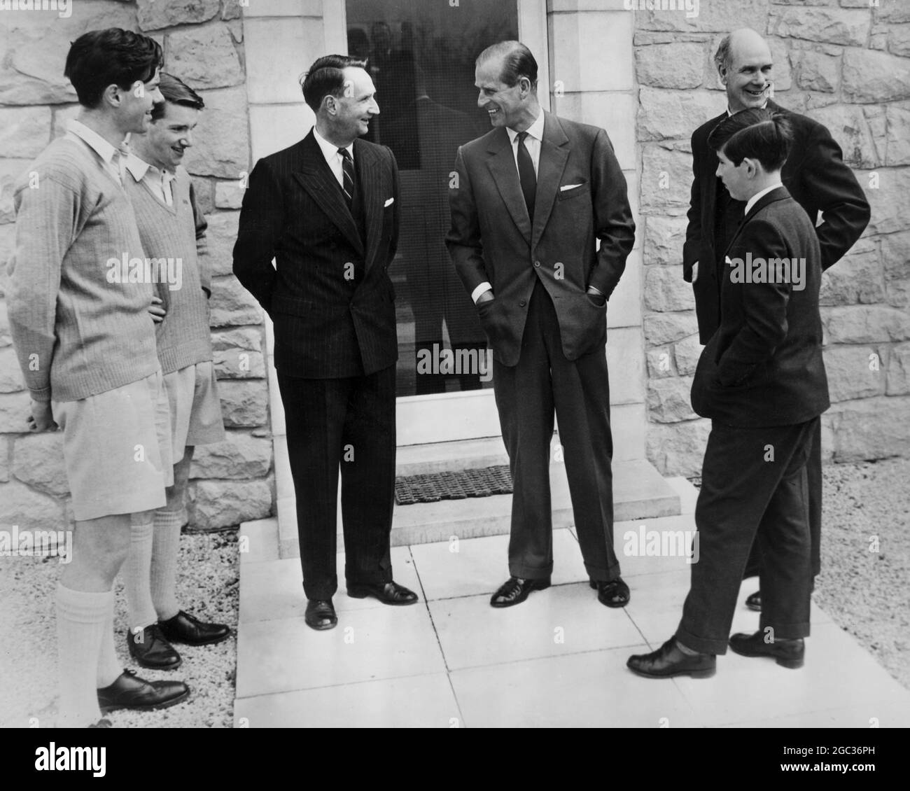 Prince Charles with his father Duke of Edinburgh go to Gordonstoun Scotland to meet housemaster Mr Robert Whitby (centre left) head boy Peter Pace (left) senior boy Dougal McKenzie (second left) and headmaster Mr Robert Chew May 2nd 1962 Stock Photo