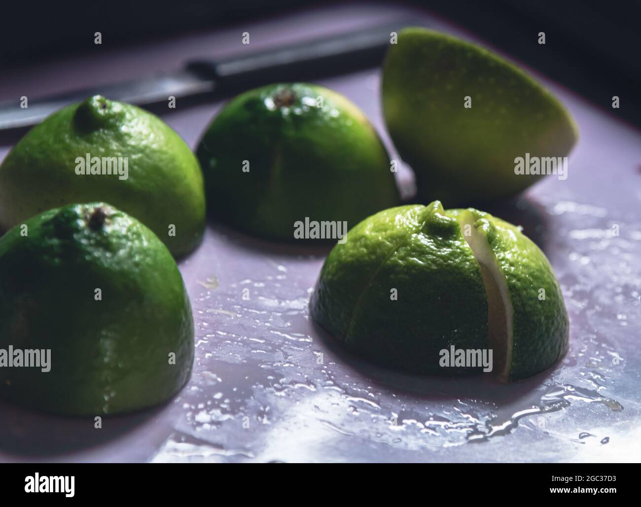 Halved Limes on a Cutting Board Stock Photo
