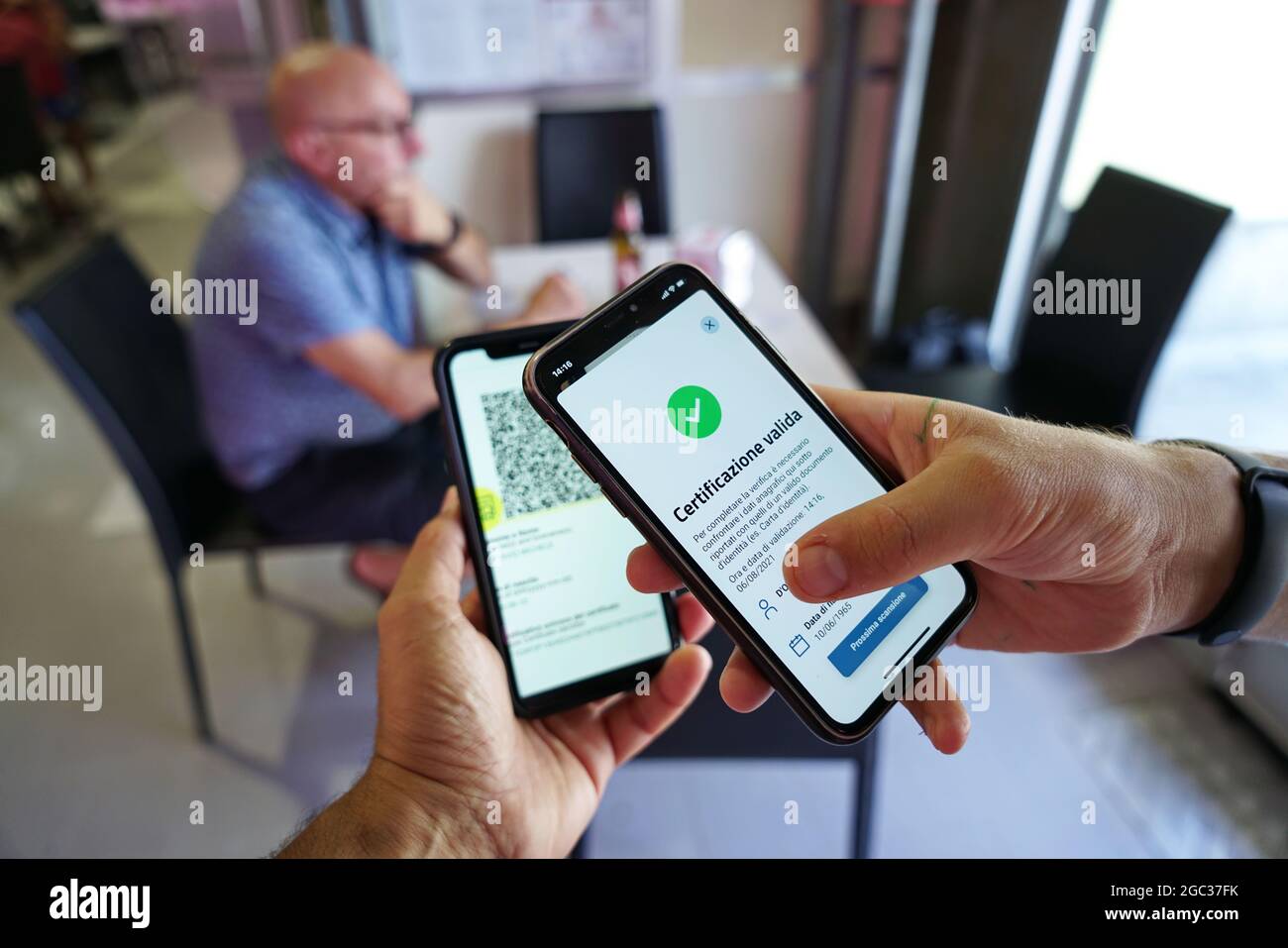 Positive green pass check on smartphone, required for indoor tables in restaurants and bars Selective focus  Turin, Italy - August 2021 Stock Photo