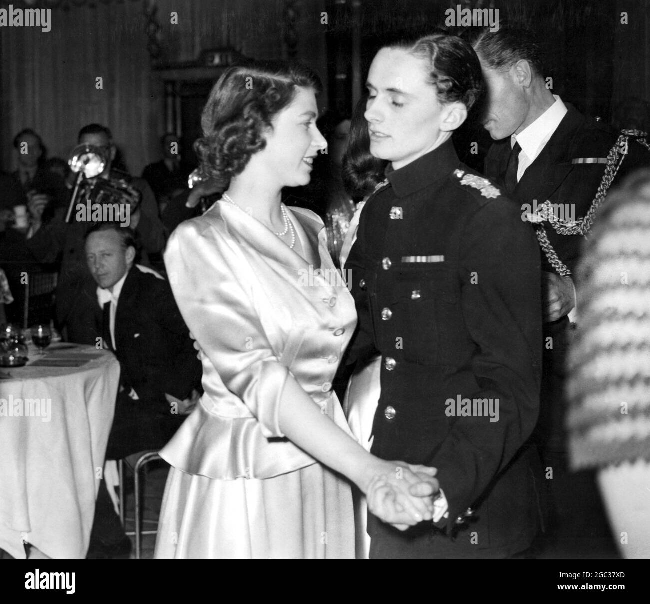 Princess Elizabeth made her first public appearance at a charity ball when she was guest of honour at the Royal and Merchant Navy Ball in aid of King George's Fund for Sailors, at the Dorchester Hotel, London. Photo shows Princess Elizabeth dancing a fox-trot with Captain Lord Rupert Nevill at the Royal and Merchant Navy Ball at the Dorchester Hotel, London - 9th May 1946 Stock Photo