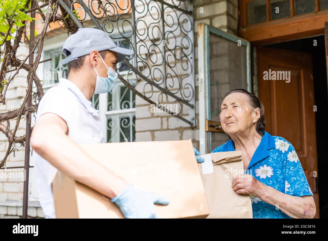 food delivery man for an elderly woman Stock Photo Alamy