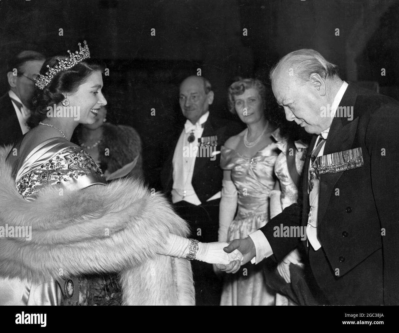 HRH Princess Elizabeth greets Mr Winston Churchill at the Guildhall dinner at which the Lord Mayor's National Thanksgiving Fund was launched. In the background can be seen the Prime Minister Mr Atlee and Mrs Atlee 23rd March 1950 Stock Photo
