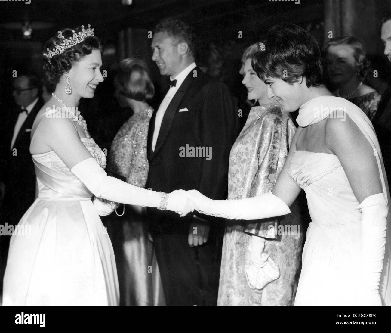 Her Majesty The Queen Elizabeth II at film premiere shakes hands with Greek actress Irene Papas one of the stars in the the film The Guns of Navarone 27 April 1961 Stock Photo