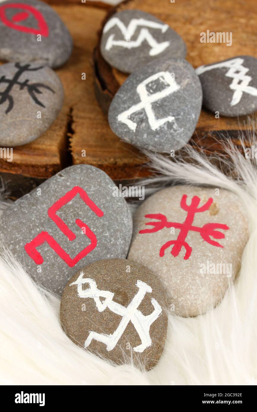Fortune telling with symbols on stones on white fur background Stock