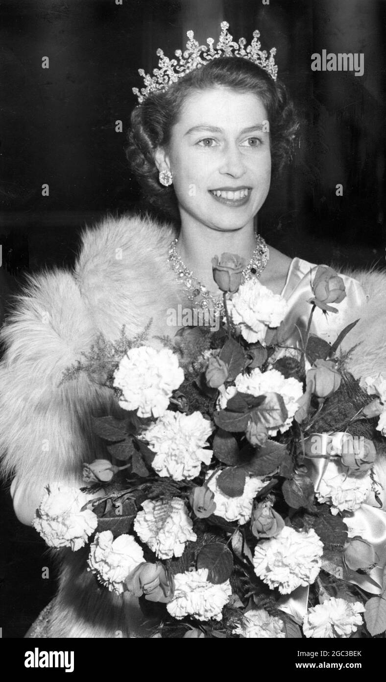 Princess Elizabeth wearing a tiara and carrying a bouquet of flowers at ...