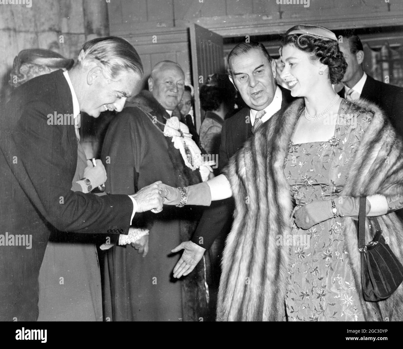 London: British premier, Sir Anthony Eden, who has been under fire from the socialists regarding the ‘Crabb Affair, in the house of commons, greets the queen, who wears a fur wrap and small close fitting hat, on her arrival at the Guildhall, where she attended a ceremony which marked the 40th anniversary of the National Savings Committee, Queen Elizabeth was scheduled to take tea with ex King Leopold of Belgium at Buckingham Palace in the afternoon. 15 May 1956 Stock Photo