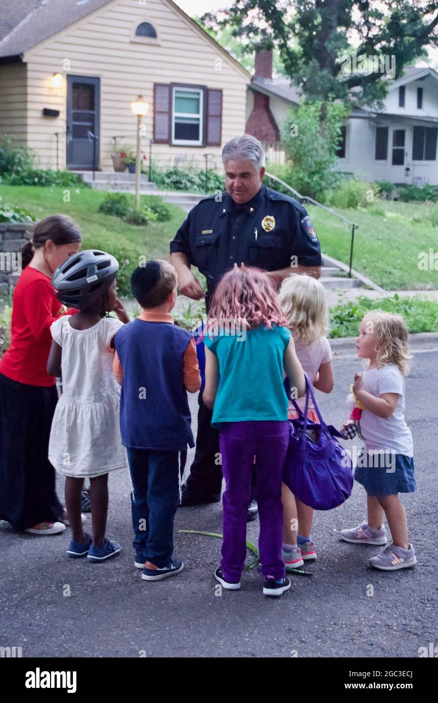 National Night Out block party in St. Louis Park, Minnesota. Diverse neighborhood gathering with children. Stock Photo
