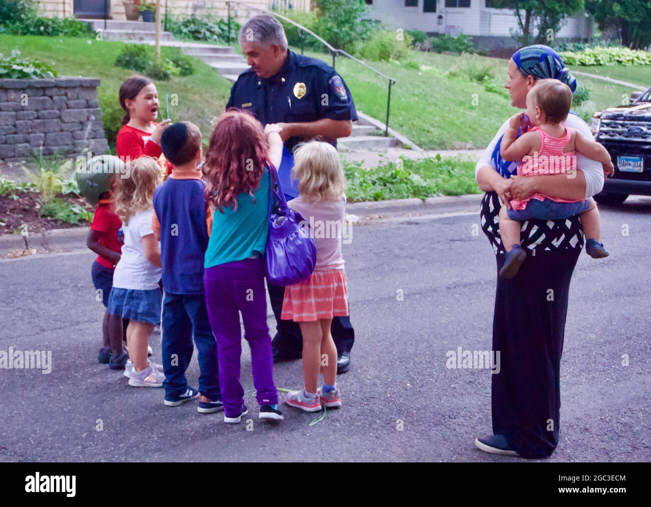National Night Out block party in St. Louis Park, Minnesota. Diverse neighborhood gathering with children. Stock Photo
