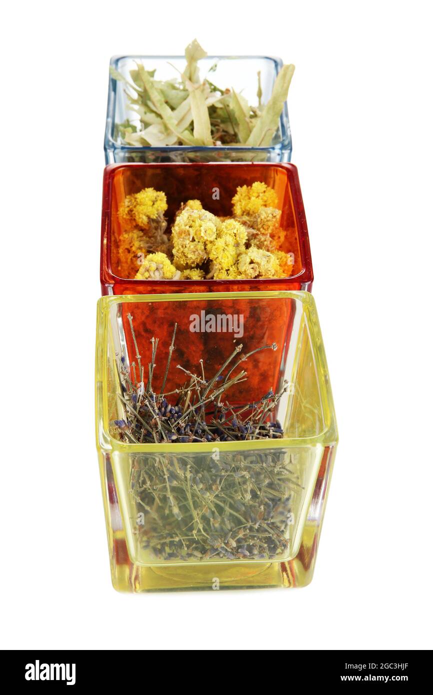 Dried herbs in glass containers isolated on white Stock Photo Alamy