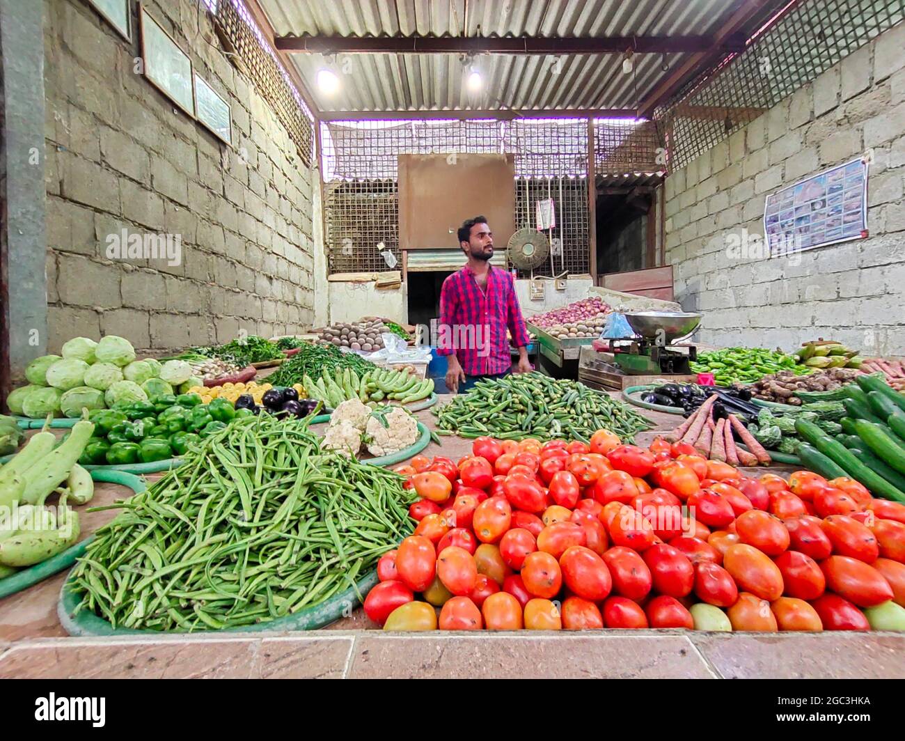 https://c8.alamy.com/comp/2GC3HKA/man-selling-vegetable-on-vegetable-shop-without-mask-during-covid-19-follow-sop-vegetable-shop-2GC3HKA.jpg