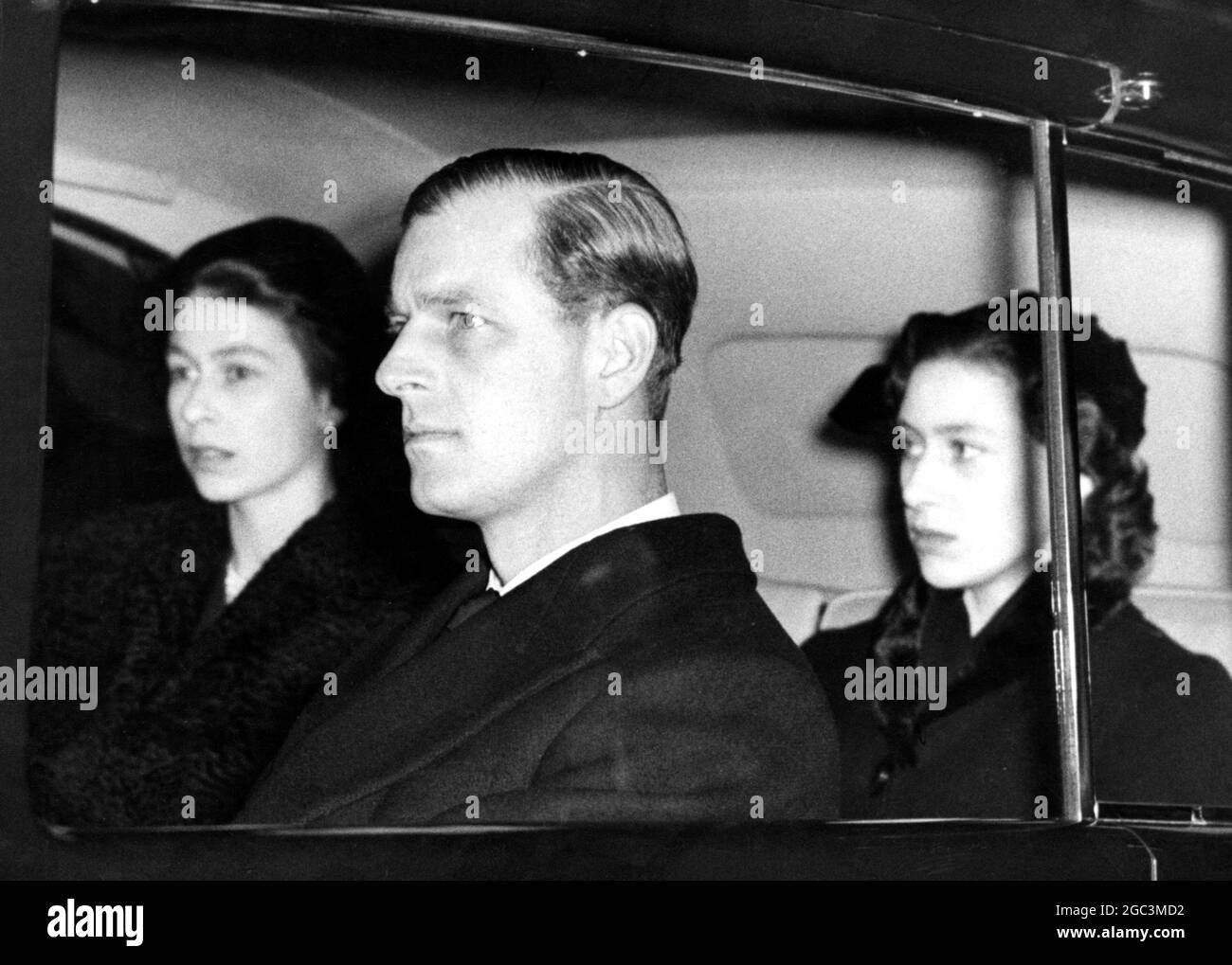 14 February 1952 Queen Elizabeth II, The Duke of Edinburgh, and Princess Margaret on the way to join mourning subjects at the bier of her father, King George VI at Westminster Hall, London, England. ©TopFoto Stock Photo
