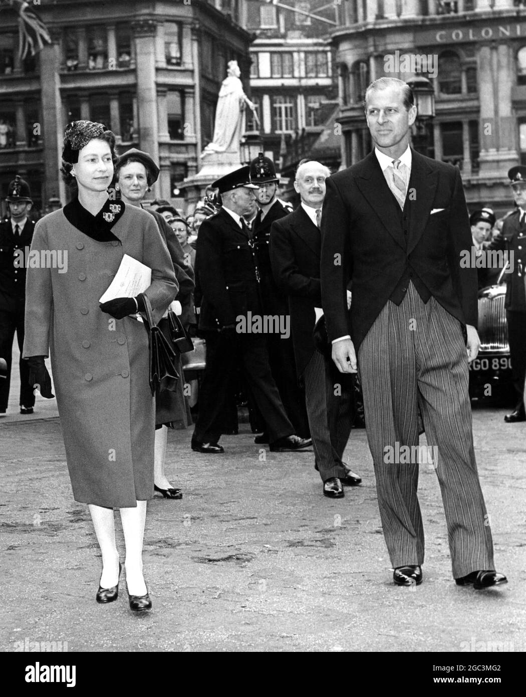 H M the Queen and the Duke of Edinburgh attend St Paul's Cathedral for the dedication of the new high altar , which is a memorial for the men and women of the commonwealth who lost their lives in the two world wars . The Queen and the Duke of Edinburgh , walk in procession to the Chapter House of St Paul's after the dedication ceremony . 7th May 1958 Stock Photo