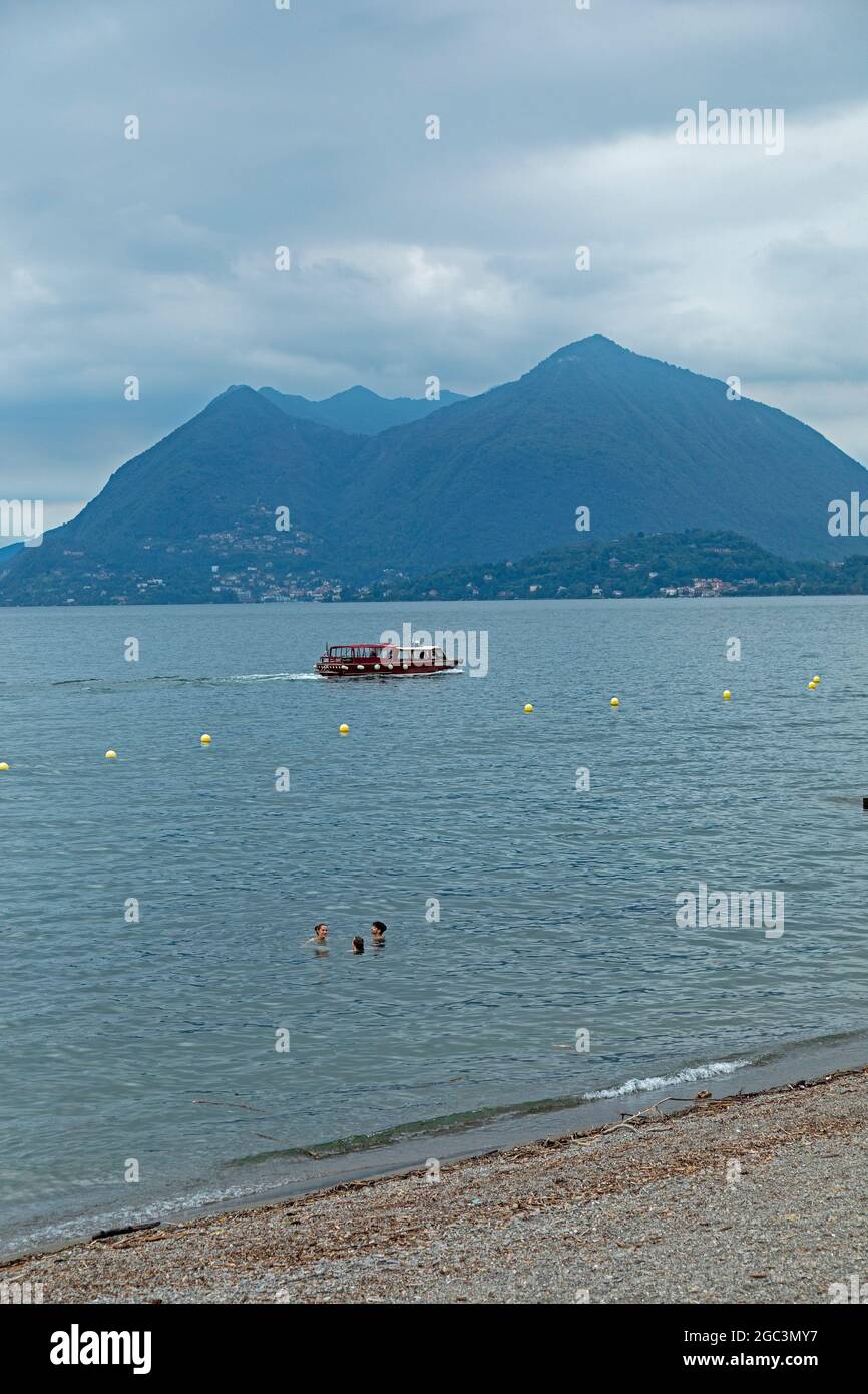 excursion boat passing Monte Sasso del Ferro, Lake Maggiore, Lombardy, Italy Stock Photo