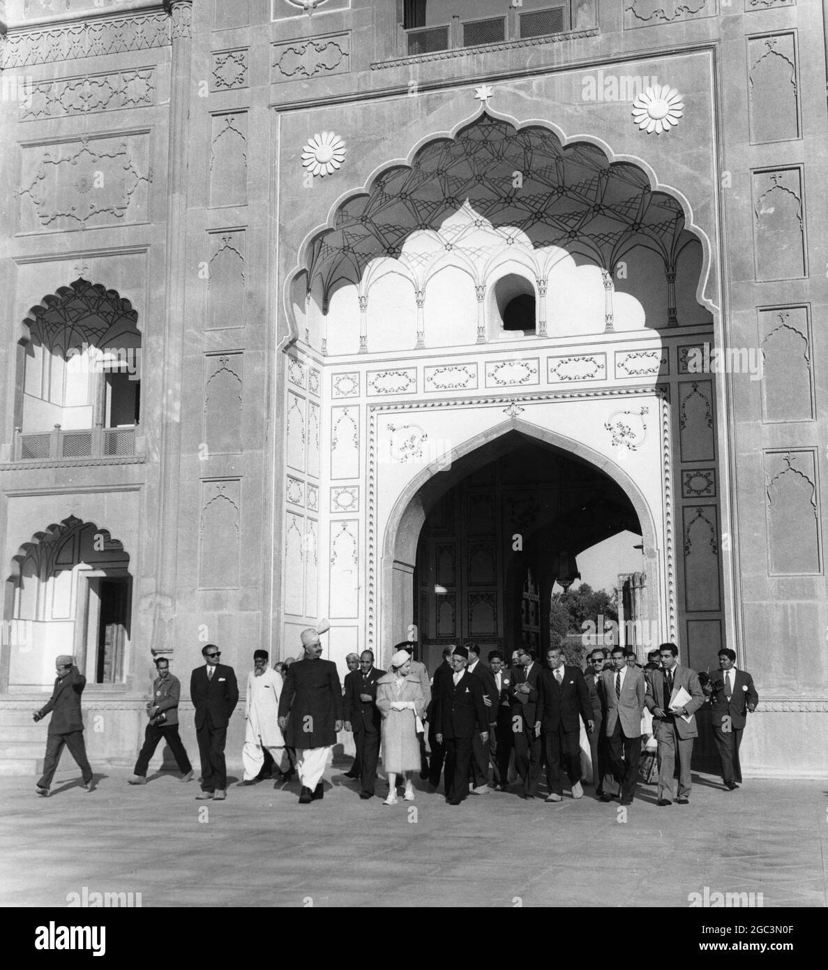 Queen Elizabeth II accompanied by the Governor of West Pakistan Mr Amir Mohammed Khan (wearing turban) seen at the 900-year-old Badshahi Mosque at Lahore , where Her Majesty laid a wreath on the tomb of the Poet philosopher Iqbal . 14th February 1961 Stock Photo