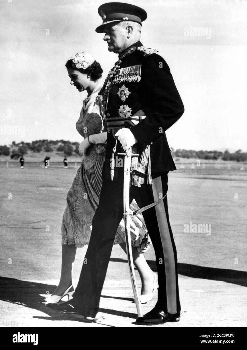 The Queen in Australia Field Marshal Sir William Slim , the Governor-General of Australia , in full dress uniform , strides alongside the Queen after Her Majesty had arrived at Fairbairn airport , Canberra . 20 february 1954 Stock Photo