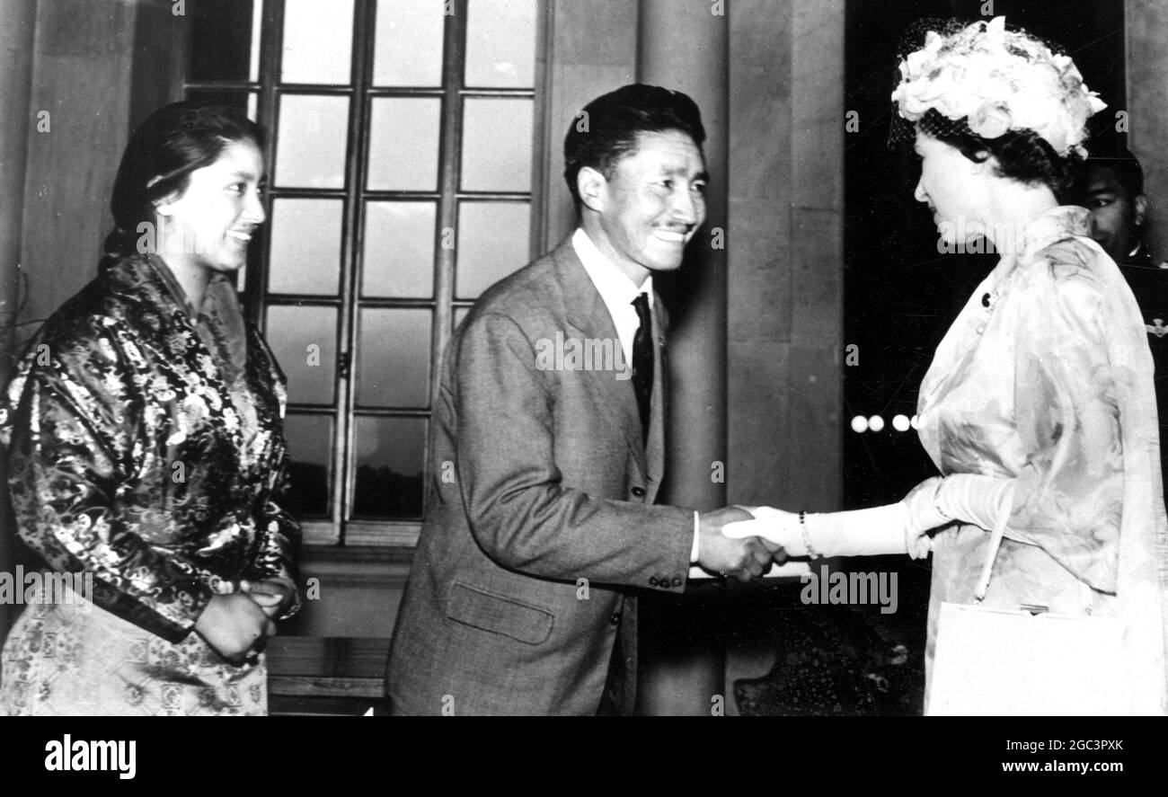 Sherpa Tensing, the Everest hero, presented a book to her Majesty Queen Elizabeth II (right), standing behind Tensing to the left is this daughter. The book was a copy of The Hero of Everest written by Brig. Gyan Singh, who led the first Indian expedition to Everest in 1960, and was published by the Publication Division of the Ministry of Information and Broadcasting. 3 February 1961 Stock Photo
