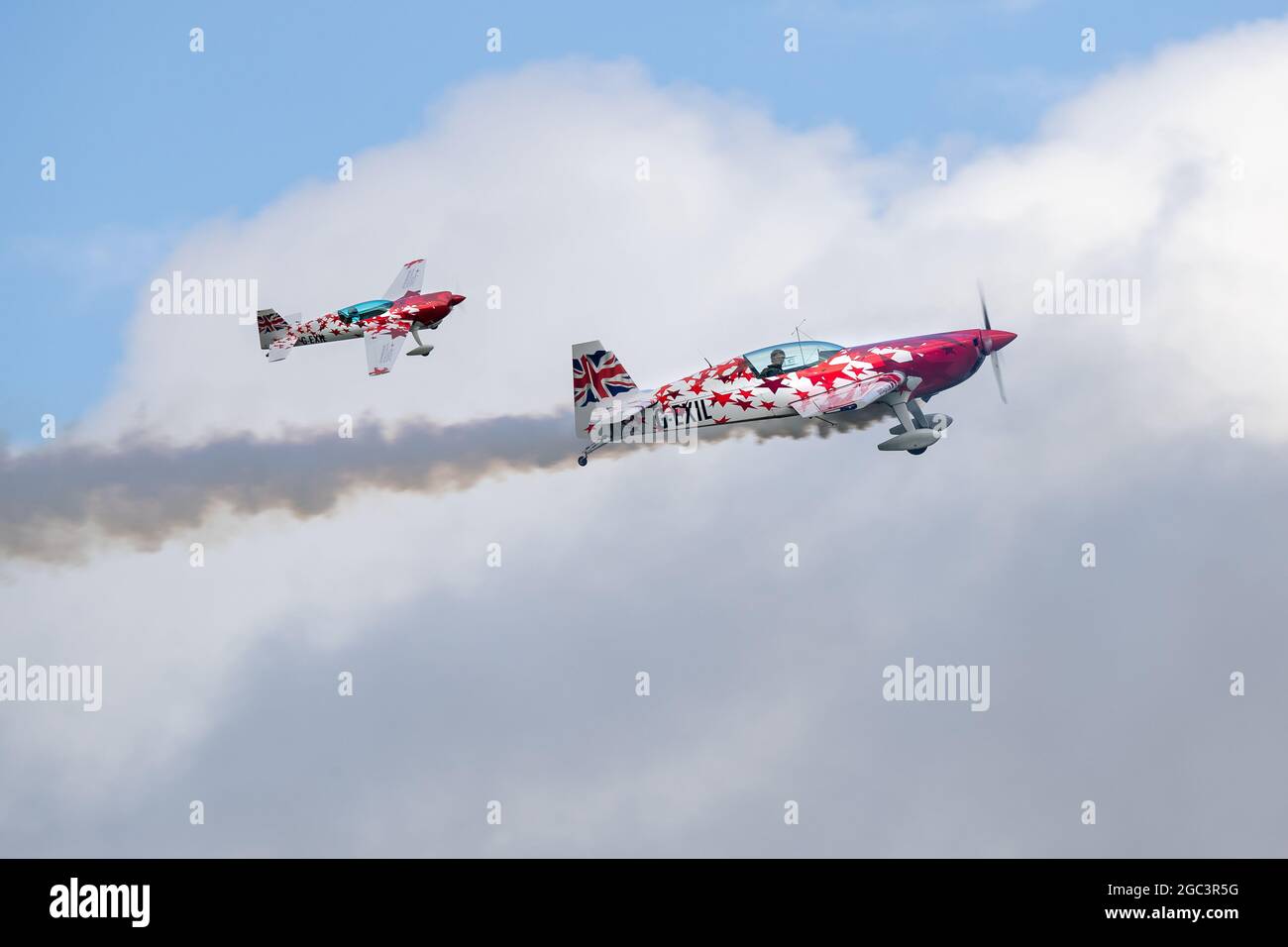 Little and large Extra Duo display team performing a fantastic aerobatic routine at Shuttleworth Family Airshow on the 1st August 2021 Stock Photo