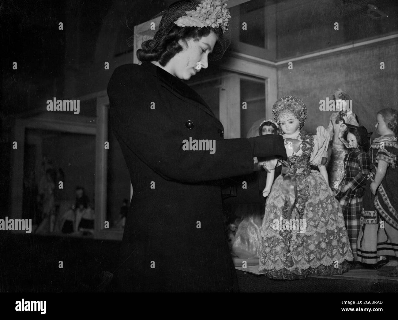 The Charter Club's exhibition of Dolls of All Nations at Hamley's, Regent Street, London, was visited today by H.R.H. Princess Elizabeth. In the exhibition are dolls with which the two princesses used to play. 26 March 1946 Stock Photo