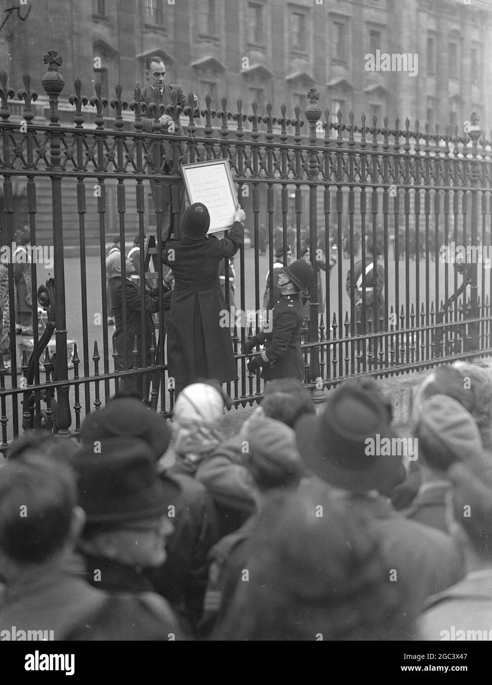 PRINCESS AND INFANT SATISFACTORY The waiting crowds outside Buckingham Palace , London surged forward to read the latest bulletin posted on the railings there. The bulletin read '' Princess Elizabeth has had some sleep during the night . Her condition and that of the infant Prince is satisfactory '' PICTURE SHOWS:- Placing this morning's bulletin on the Buckingham Palace railings . 15 November 1948 Stock Photo