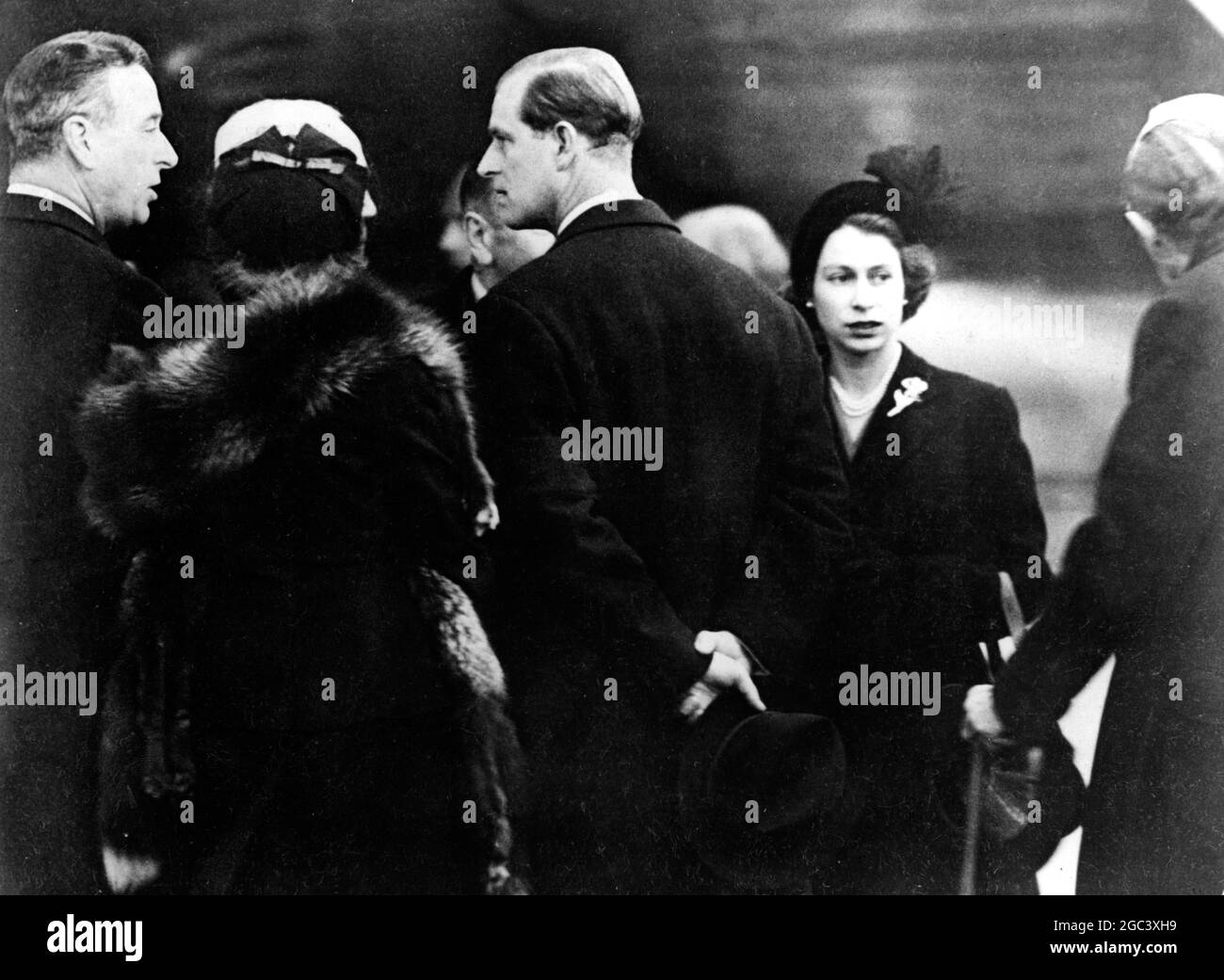 Whilst on tour in Kenya with her husband , the Duke of Edinburgh , Princess Elizabeth , as she was then , heard of the death of her father , King George VI at Sandringham , she immediately flew home . She automatically assumed the title of monarch and thus becomes Queen Elizabeth II . LtoR at London Airport on arrival are Earl Mountbatten , an unidentified woman , the Duke of Edinburgh , Queen Elizabeth II and an unidentified man . 7 February 1952 Stock Photo