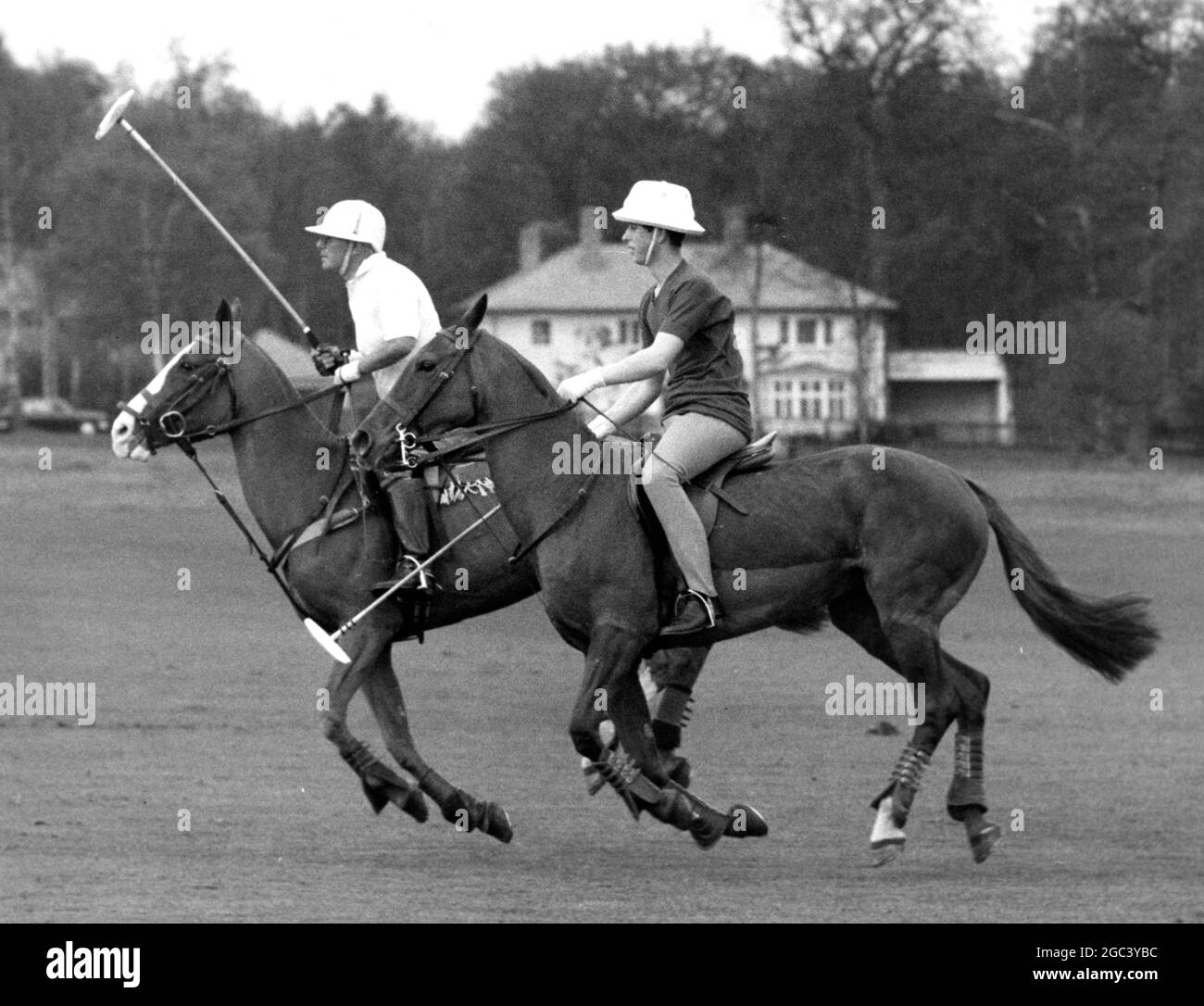 Polo at Smith's Lawn , Windsor . Prince Charles played a practice polo match , and was later joined in play by Prince Philip , who had previously played for Priar Park against the Household Brigade . Seen Charles (nearest) rides off an opponent during the match . 24 April 1965 Stock Photo