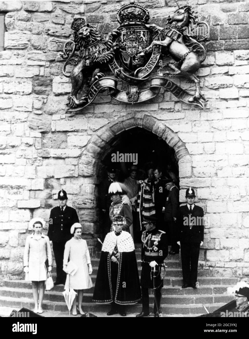 The ceremony over Prince Charles , the newly invested Prince of Wales faces his people once again ... as he leaves Watergate , one of the entrances to the ancient Caernarvon Castle . The 20 year old Prince is accompanied by his father Prince Philip , his mother Queen Elizabeth II who performed the investitude ceremony , and his sister , Princess Anne . They are followed by Lord Snowdon ( background right ) and the silver haired Duke of Norfolk , chief organiser of this historic , colourful event which has not taken place since 1911 when the present Duke of Windsor became Prince of Wales . 1 Ju Stock Photo