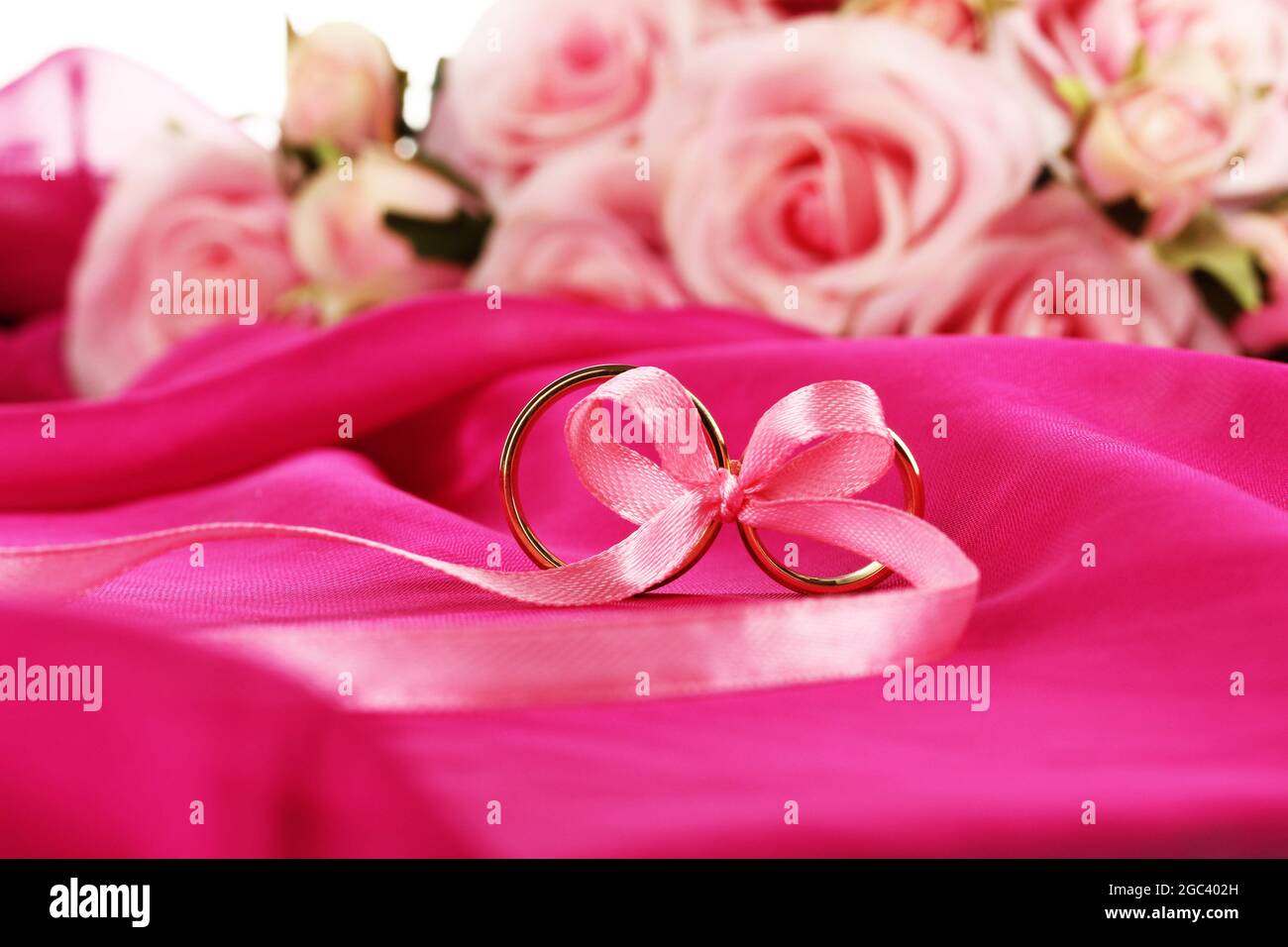 Wedding rings tied with ribbon Stock Photo - Alamy