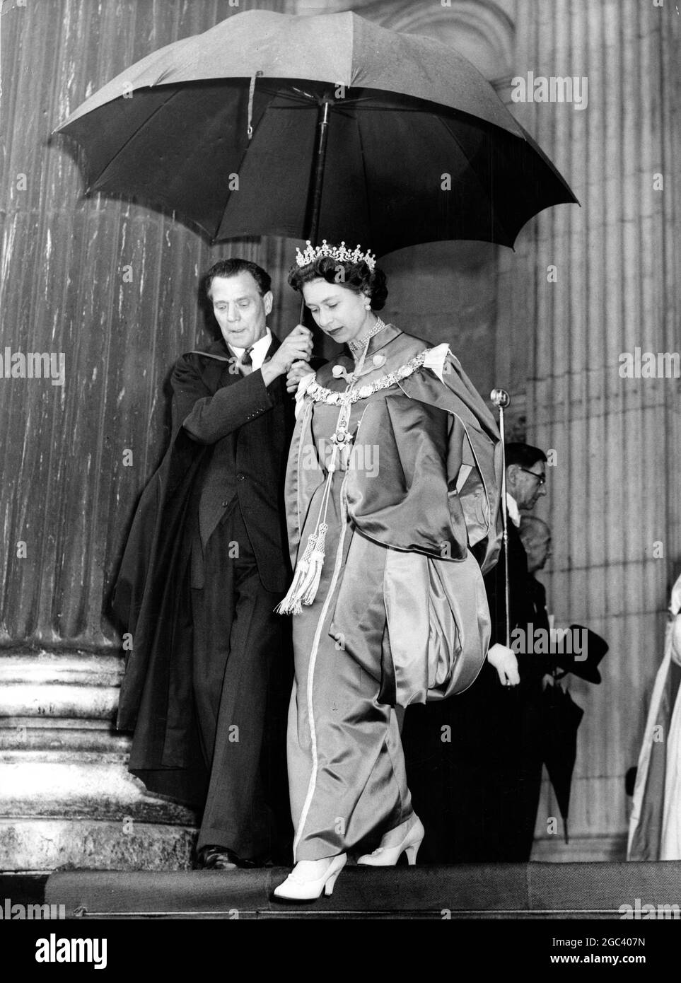 An umbrella for the Queen , dressed in the robes of the Order of the British Empire , as she leaves St Paul's Cathedral this morning after attending the service of dedication of the New Chapel of the Order , London , England . The Duke of Edinburgh , who also attended the service , follows a few paces behind . 20 May 1960 Stock Photo