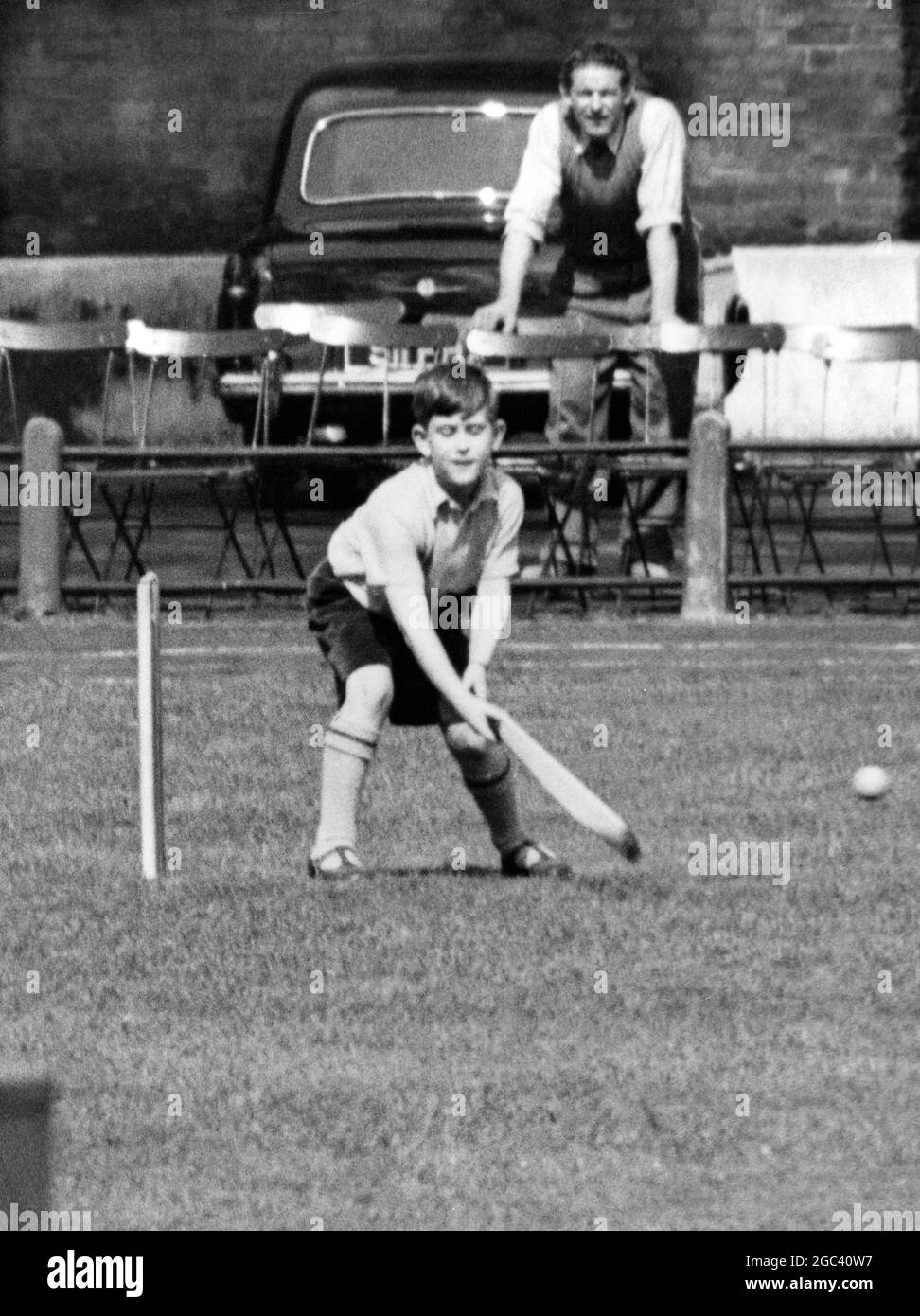 Prince Charles Batsman - cricket - playing with schoolmates on a games field near his Knightsbridge, London prep school on Wednesday. 1 May 1957 Stock Photo