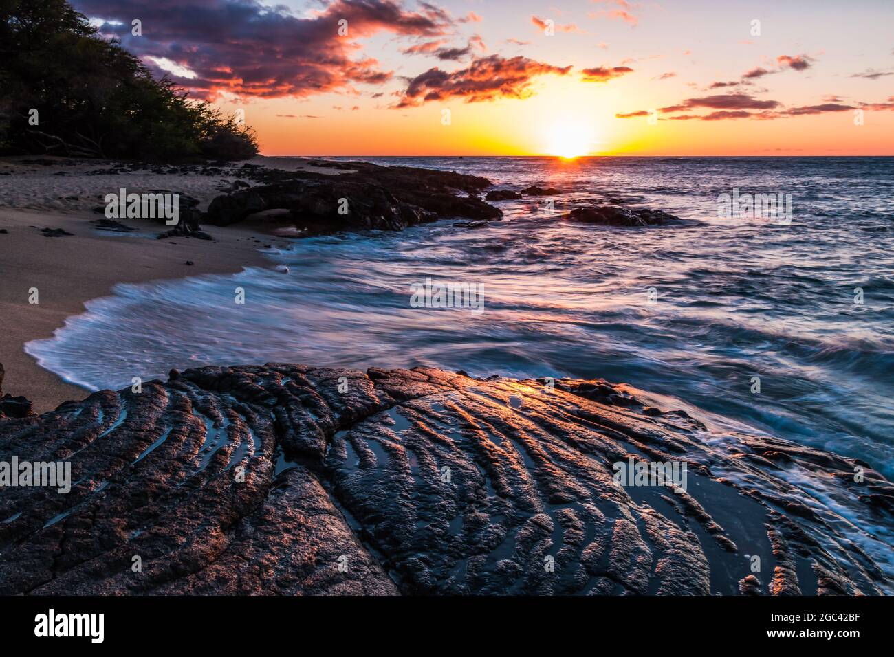 Waves Washing Over Ancient Lava Flows on Kapalaoa Beach at Sunset, Anaeho'omalu Bay, Hawaii Island, Hawaii, USA Stock Photo