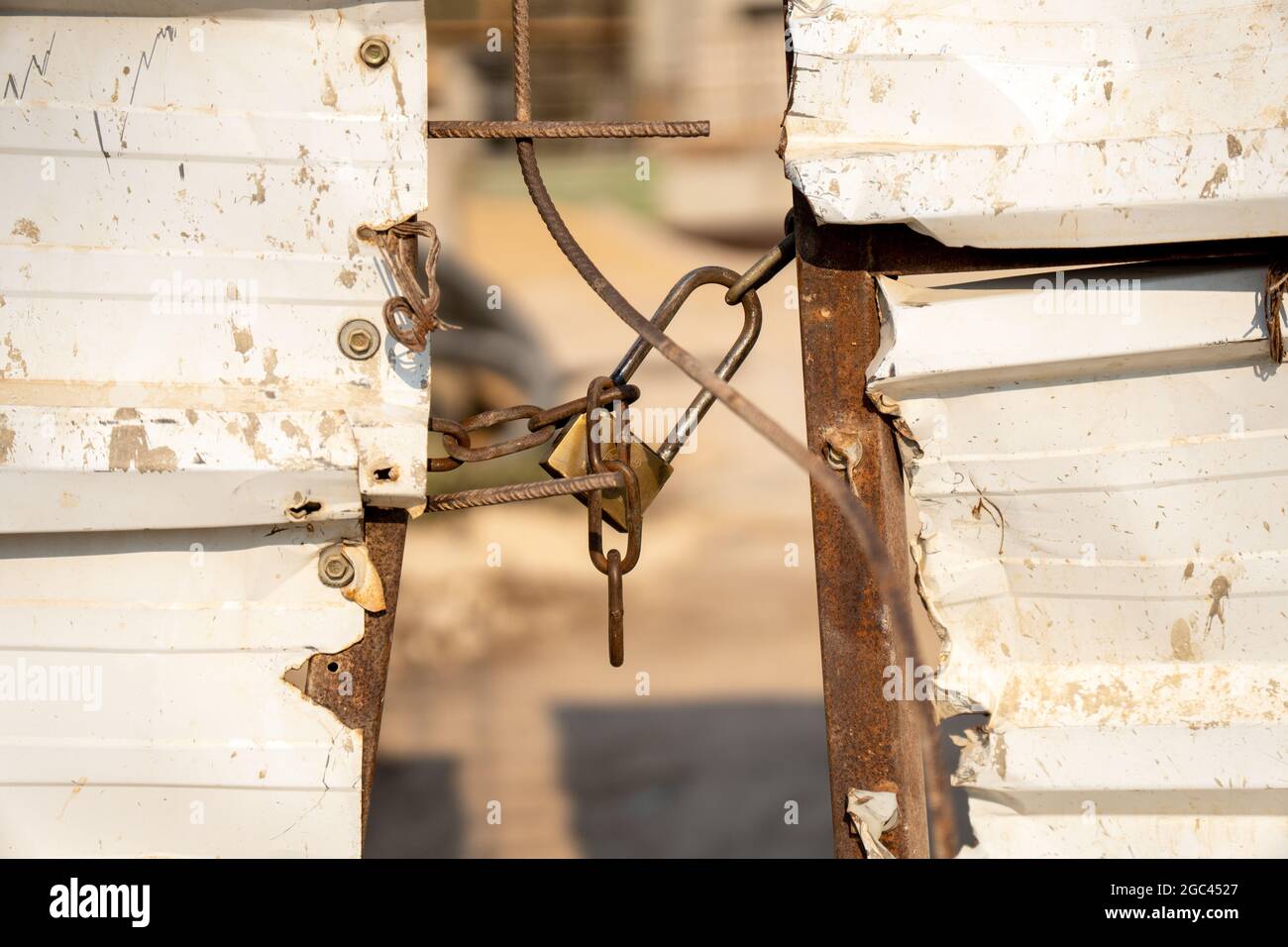 Metal lock on gate of construction site Stock Photo