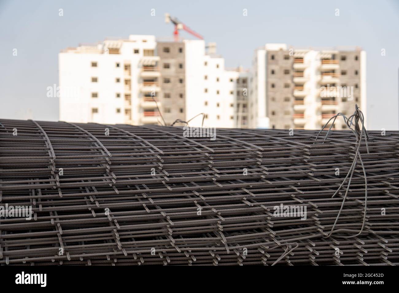 Reinforced steel bars on background of construction site with copy space. Metal base of reinforced concrete walls and buildings. Stock Photo