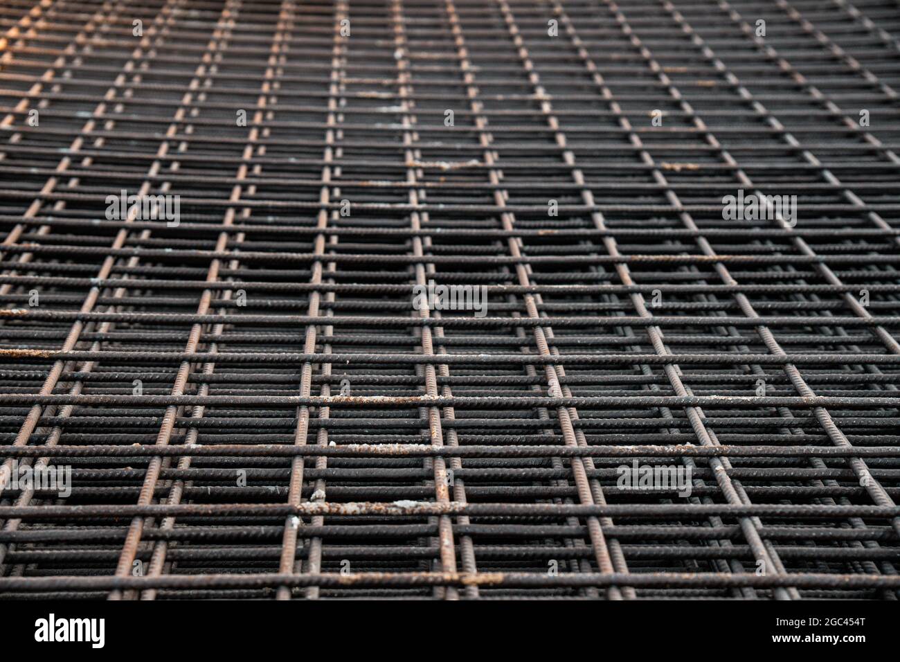 Reinforced steel bars on background of construction site with copy space. Metal base of reinforced concrete walls and buildings. Stock Photo