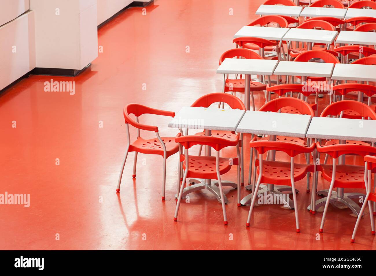 Interior of a restaurant with row of red chairs Stock Photo Alamy