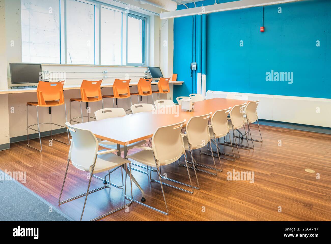 Office kitchen and lunch room with large table and chairs Stock Photo