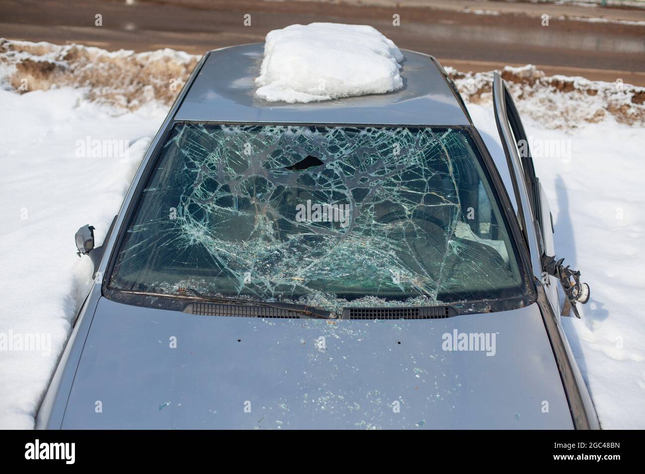 Broken car glass. The windshield cracked. Damaged transport. The car is
