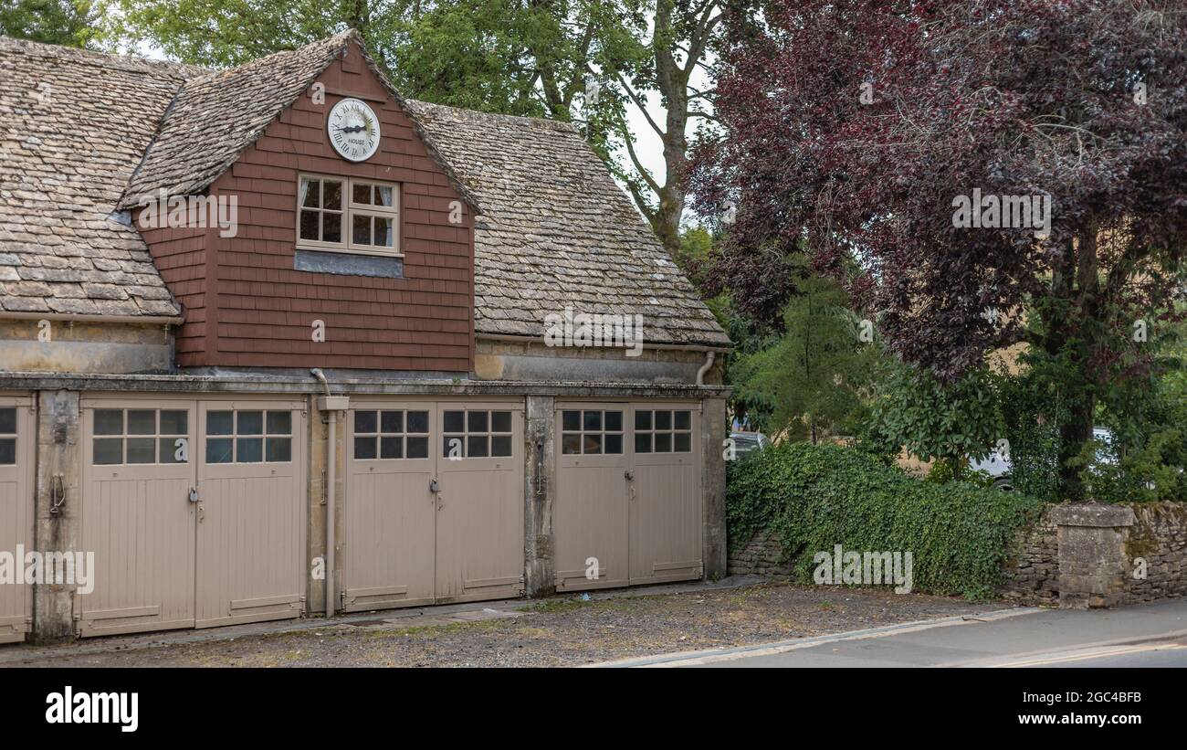 Old clock house with garages Stock Photo Alamy