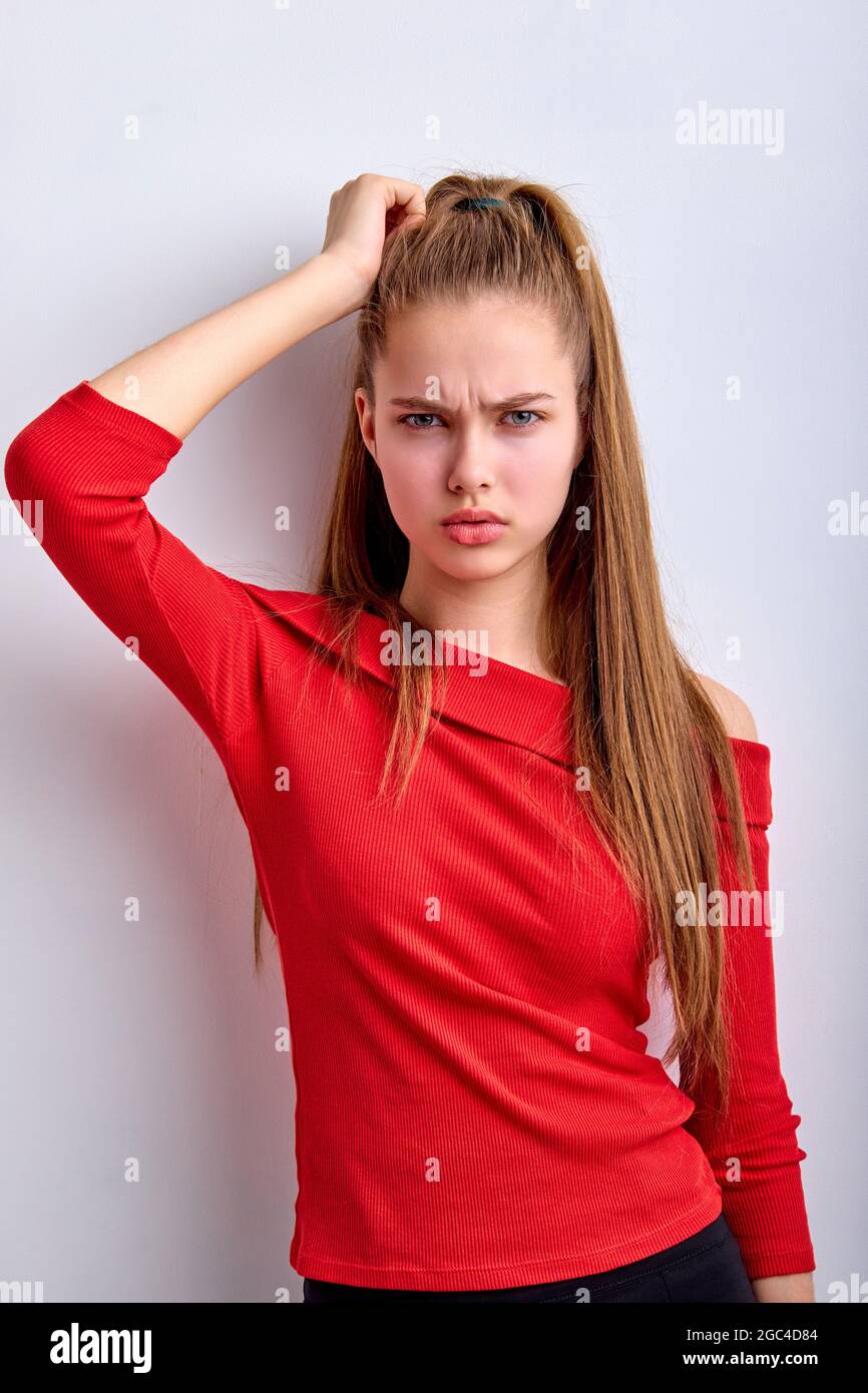 Puzzled perplexed young girl with distrustful face isolated on white