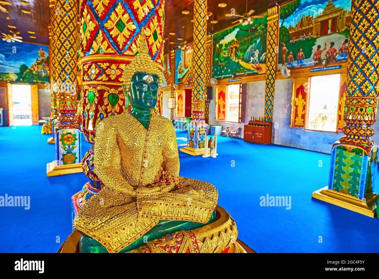LAMPHUN, THAILAND - MAY 8, 2019: The Emerald Buddha in golden attire in Wat Chammathewi Assembly Hall (Viharn), on May 8 in Lamphun Stock Photo
