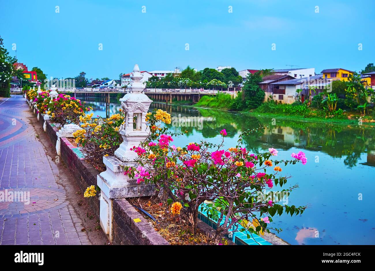 Embankment of Wang river is decorated with bright bougainvillea flowers and  small white mondops (mini-pavilion), Lampang, Thailand Stock Photo - Alamy