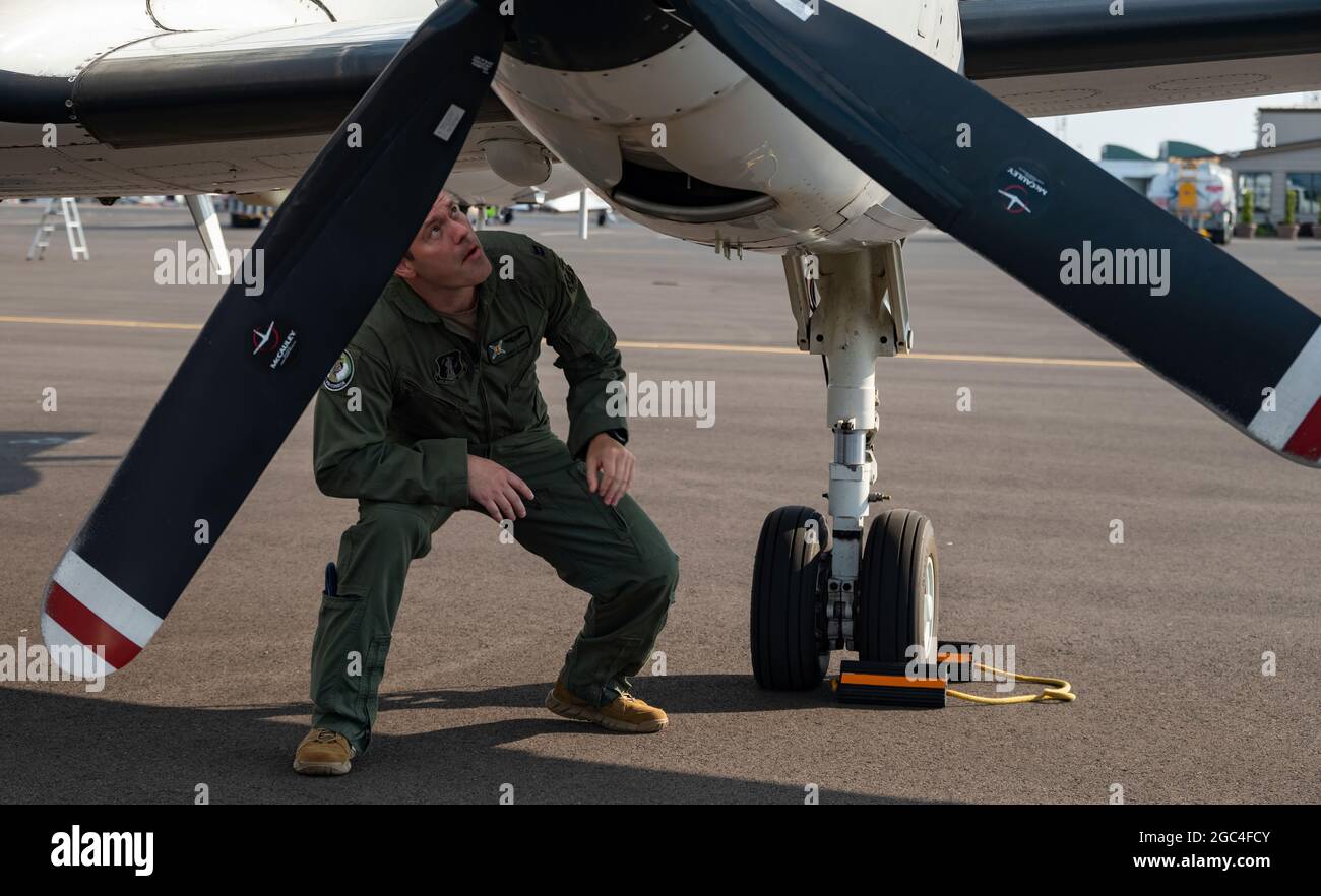 Capt. Chris Coenen, 187th Fighter Wing, Alabama Air National Guard, RC-26B pilot, performs a preflight check of the U.S. Air Force RC-26B Metroliner aircraft prior to departing for a wildland fire mapping and detection mission in support of the U.S. Forest Service at the Eugene Airport, Eugene, Ore., August 1, 2021. Coenen is flying with the 141st Air Refueling Wing, Washington Air National Guard. The RC-26 is tasked with utilizing its highly mobile platform by making infrared images and video of the fires from above in order to map and detect wildland fires and hotspots in the western region Stock Photo