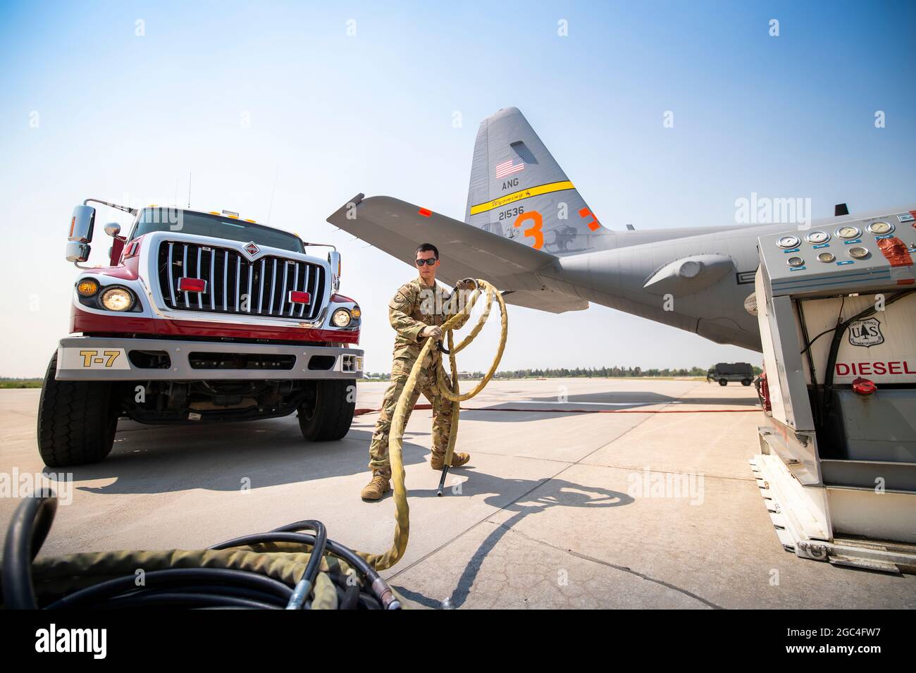 Members assigned to the 153d Airlift Wing prepare and load a C-130 Hercules aircraft with a Modular Airborne Fire Fighting System (MAFFS) at the Wyoming Air National Guard base, Cheyenne, Wyo. July 19, 2021. The USDA Forest Service activated the MAFFS-equipped C-130H aircraft through a DoD request for assistance and will be operating out of McClellan Park, Calif., the MAFFS teams are managed by First Air Force (Air Forces Northern)’s 153rd Air Expeditionary Group. (U.S. Air National Guard photo by Tech. Sgt. Jon Alderman) Stock Photo