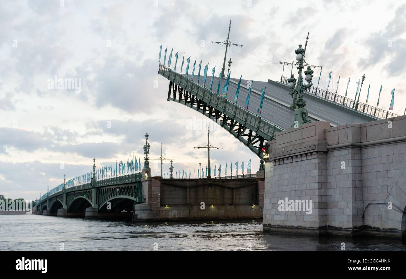 Trinity bridge with its part raised is halfway down to the regular position, at 3:53 am, St Petersburg, Russia Stock Photo