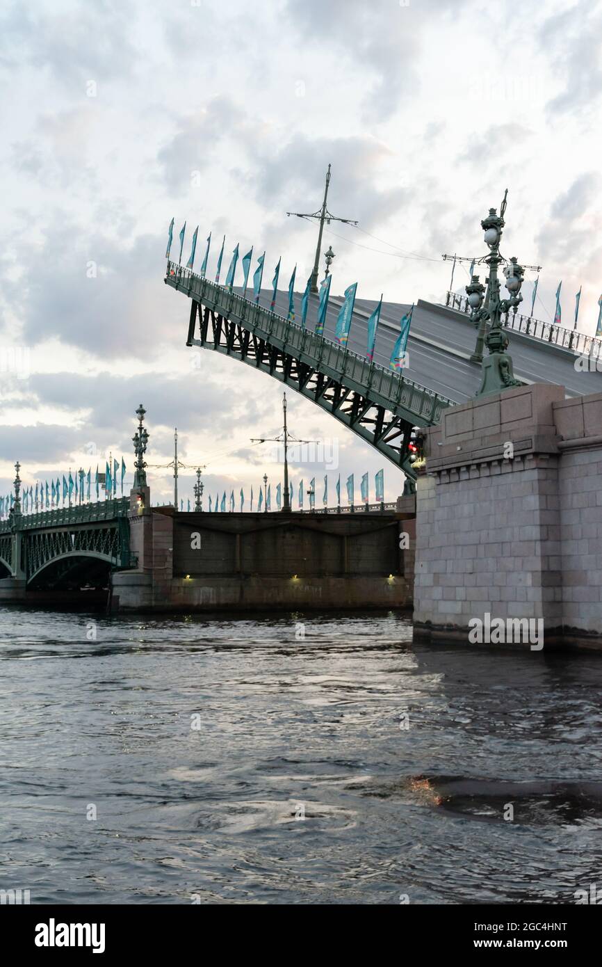 Trinity bridge over Neva river with its part raised is halfway down to the regular position, at 3:53 am, St Petersburg, Russia Stock Photo