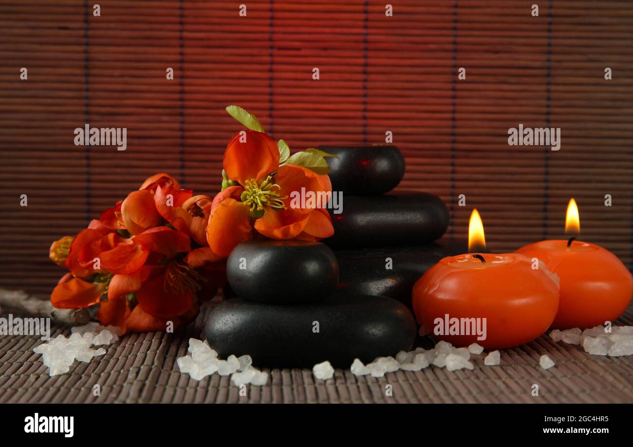 Spa stones with flowers and candles on bamboo background Stock Photo ...