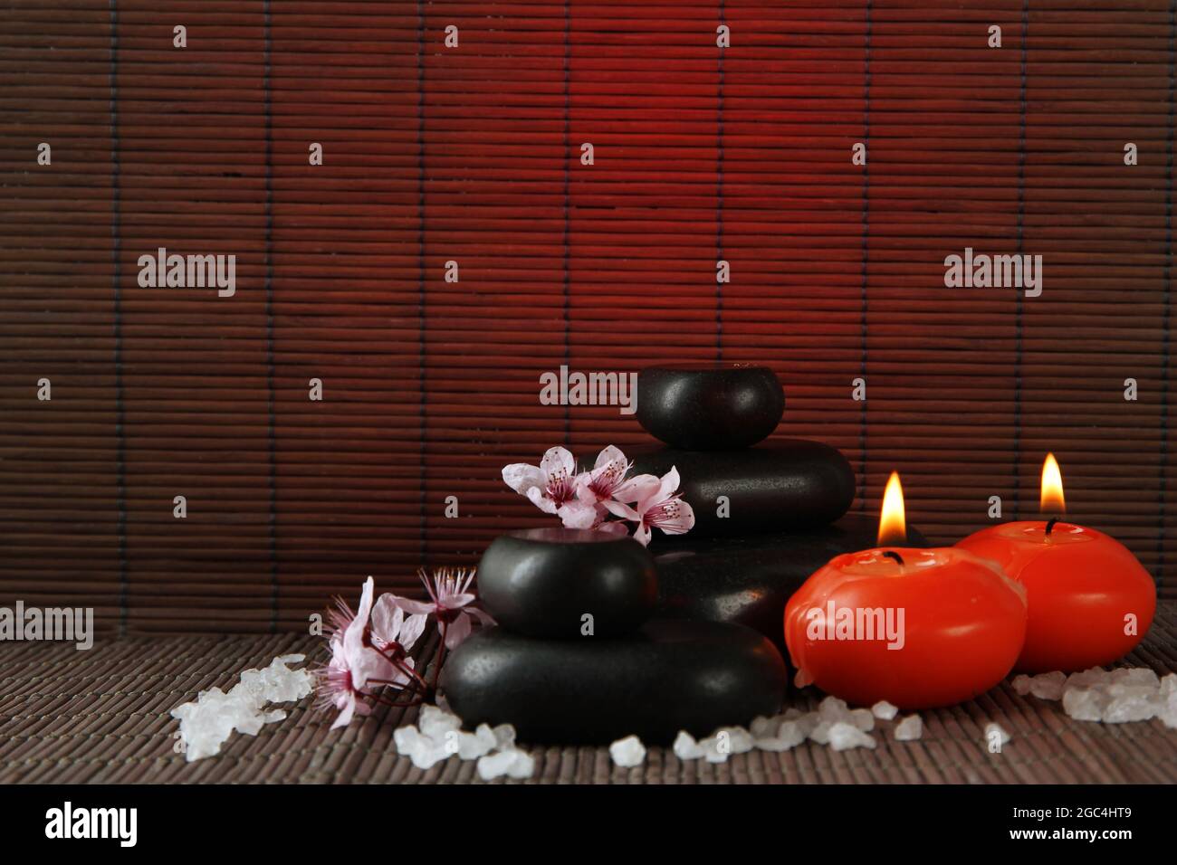 Spa stones with flowers and candles on bamboo background Stock Photo ...