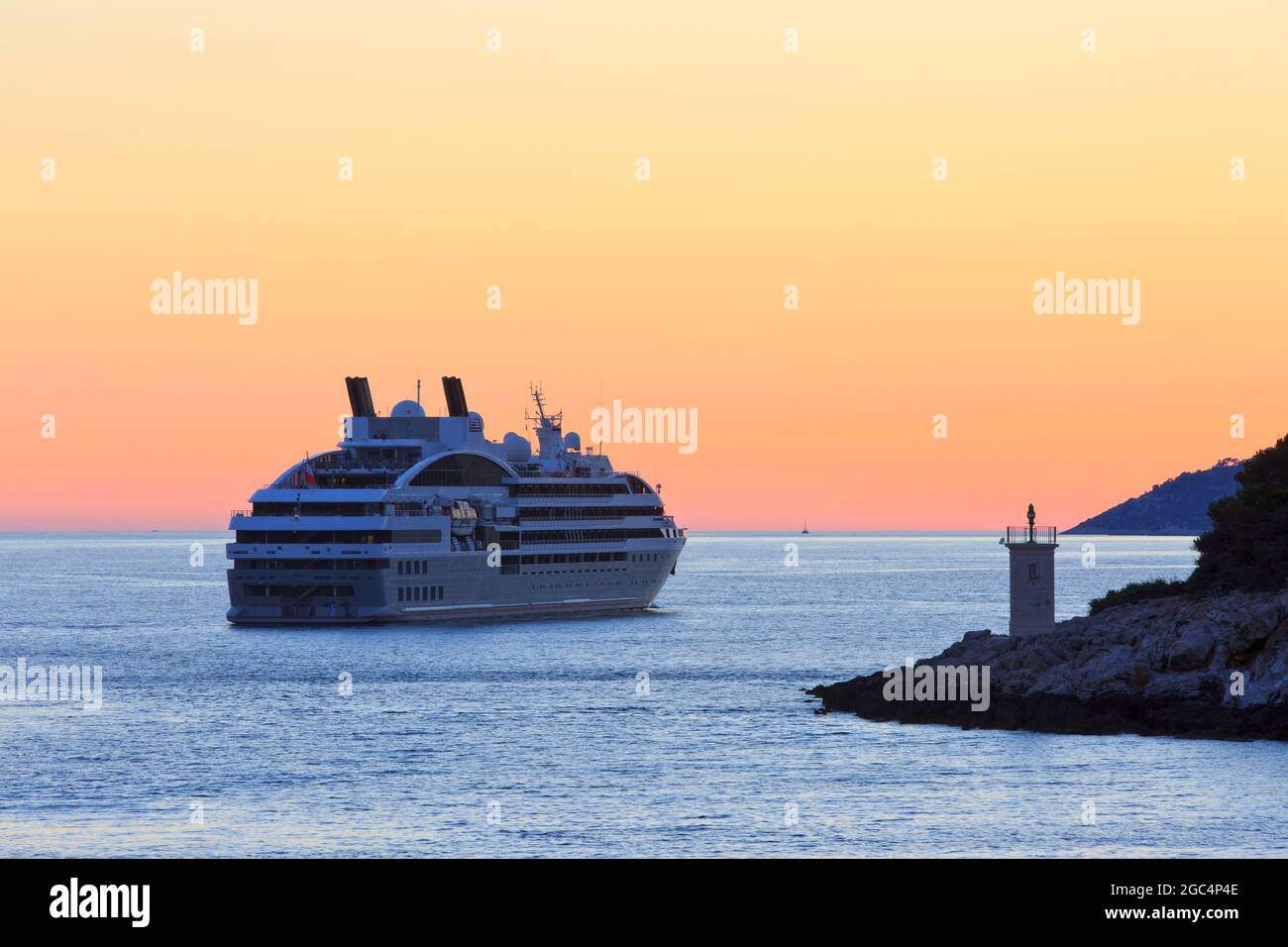 Le Lyrial (2015) cruise ship sailing past Galisnik Island in Hvar, Croatia at sundown Stock Photo